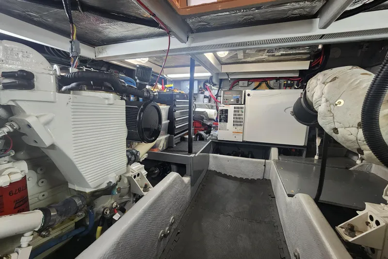 Slide: The Image of Engine room of a 2003 Meridian 411 Sedan, showcasing mechanical components and wiring. - 57