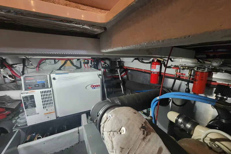 Slide: The Image of Engine room of 2003 Meridian 411 Sedan with Onan marine generator and fire extinguisher. - 60