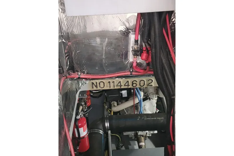 Slide: The Image of Engine room of 2003 Meridian 411 Sedan with wiring and fire extinguisher visible. - 62