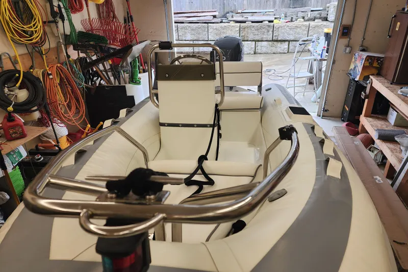 Slide: The Image of Inflatable boat in garage with tools, featuring a Meridian 411 Sedan, 2003 model. - 70