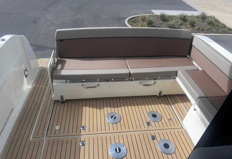 Slide: The Image of Bayliner T29EX 2026 featuring comfortable seating and wooden deck. - 11