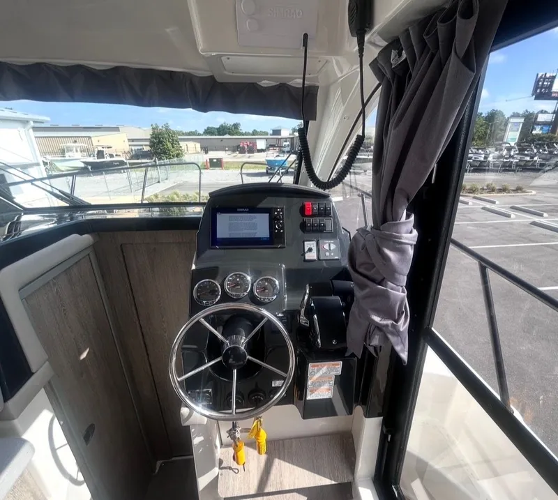 Slide: The Image of Interior view of 2026 Bayliner T29EX helm with modern controls. - 14