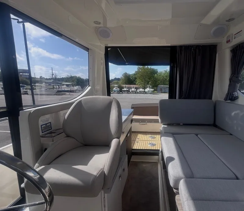 Slide: The Image of Interior of 2026 Bayliner T29EX with seating area and helm. - 18