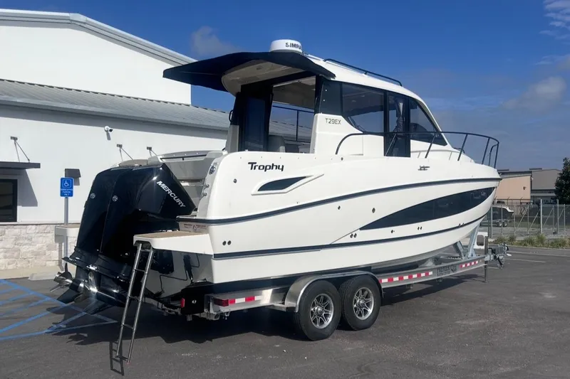 The Image of 2026 Bayliner T29EX boat on trailer, side view. - 3