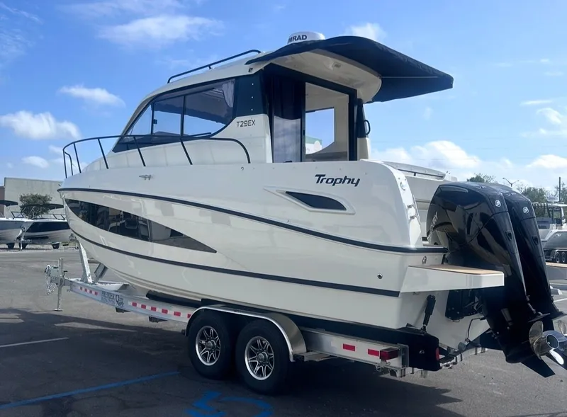 Slide: The Image of 2026 Bayliner T29EX boat on trailer, side view. - 6