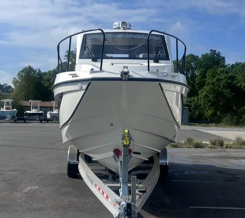 Slide: The Image of 2026 Bayliner T29EX boat on trailer, front view outdoors. - 8