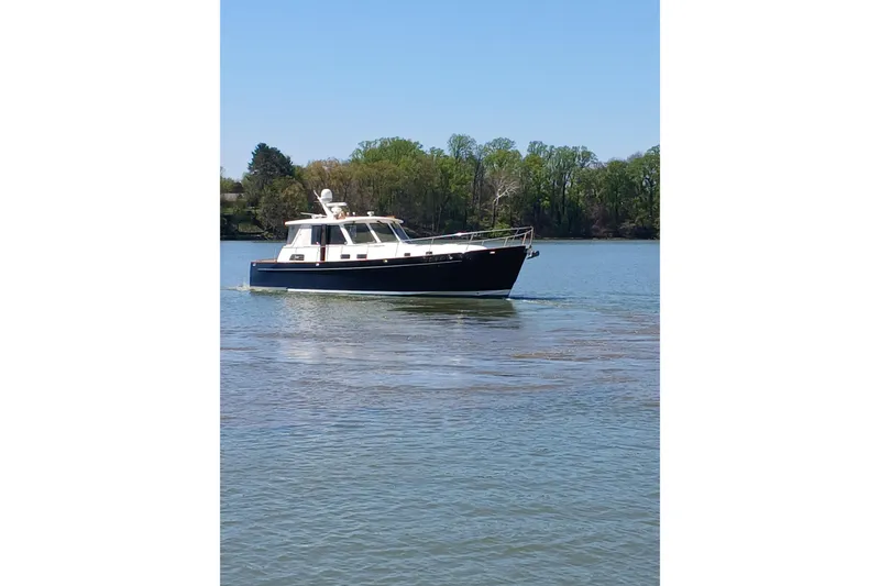 Slide: The Image of 2002 Legacy Yachts 52 Express docked, featuring spacious deck and elegant design. - 10