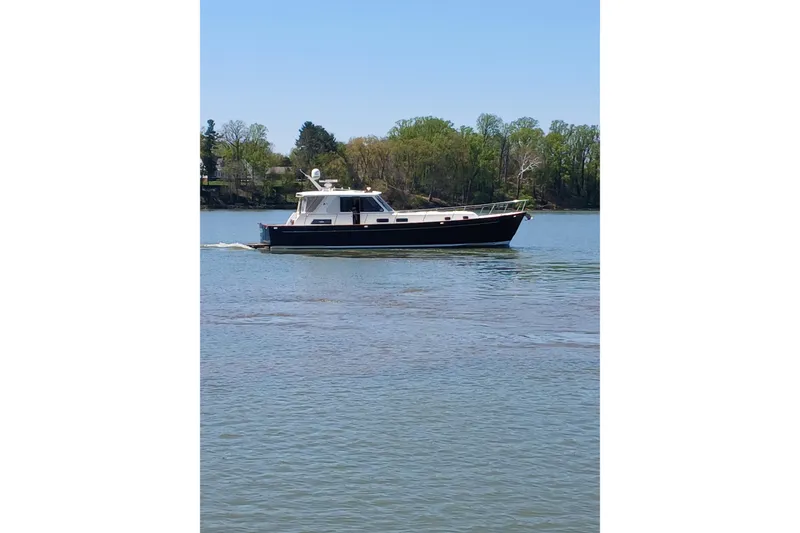 Slide: The Image of Luxurious interior of 2002 Legacy Yachts 52 Express with plush seating and wooden flooring. - 12