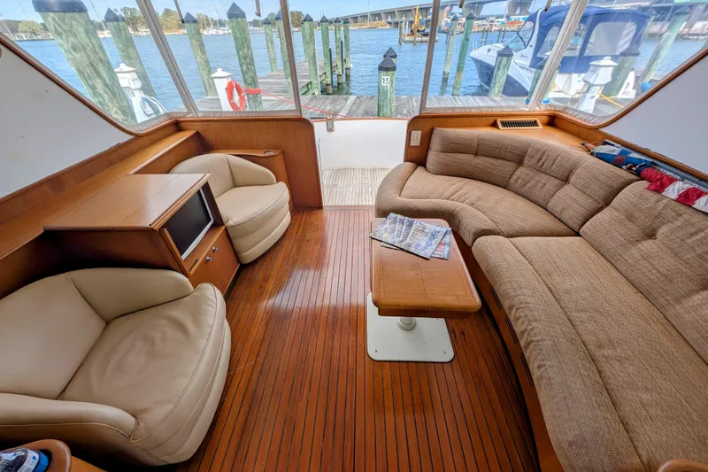 Slide: The Image of Luxurious interior of 2002 Legacy Yachts 52 Express with plush seating and wooden flooring. - 13