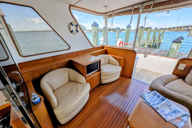 Slide: The Image of Interior of 2002 Legacy Yachts 52 Express with seating and waterfront view. - 14