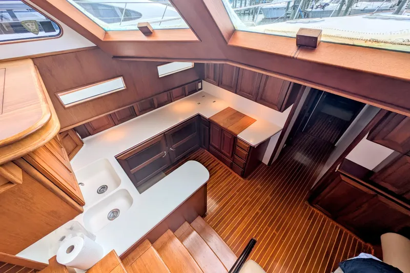 Slide: The Image of Luxurious 2002 Legacy Yachts 52 Express interior with wooden cabinetry and modern kitchen amenities. - 17