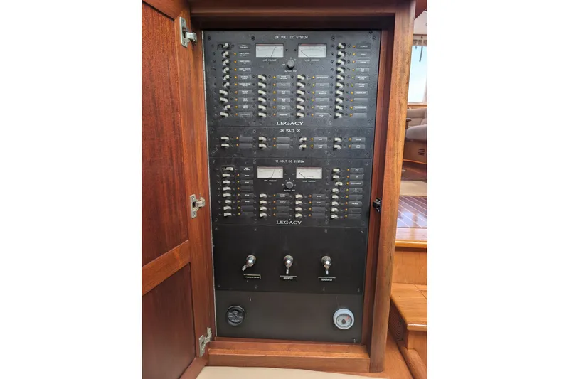 Slide: The Image of Electrical panel inside 2002 Legacy Yachts 52 Express, featuring switches and controls. - 18