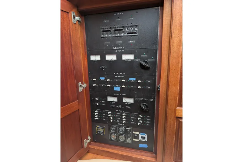 Slide: The Image of Electrical panel of 2002 Legacy Yachts 52 Express, featuring switches and gauges. - 19