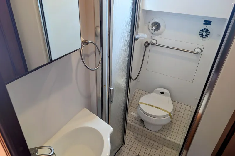Slide: The Image of Bathroom interior of 2002 Legacy Yachts 52 Express, featuring shower and toilet. - 20