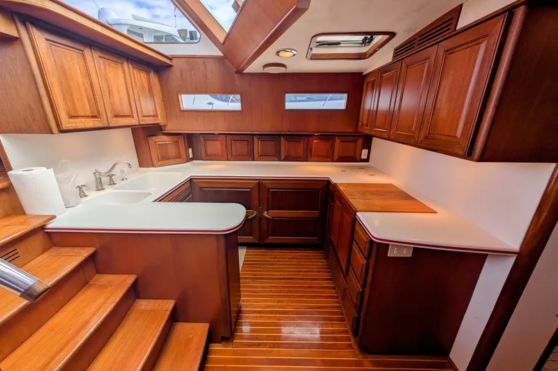 Slide: The Image of Luxurious wooden interior of 2002 Legacy Yachts 52 Express, featuring elegant cabinetry and countertops. - 26