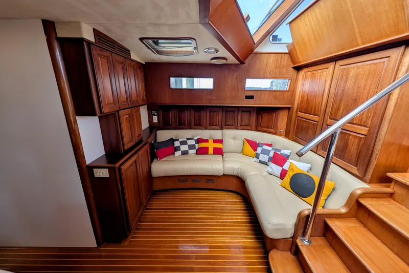 Slide: The Image of Luxurious 2002 Legacy Yachts 52 Express interior with wood paneling and plush seating. - 27