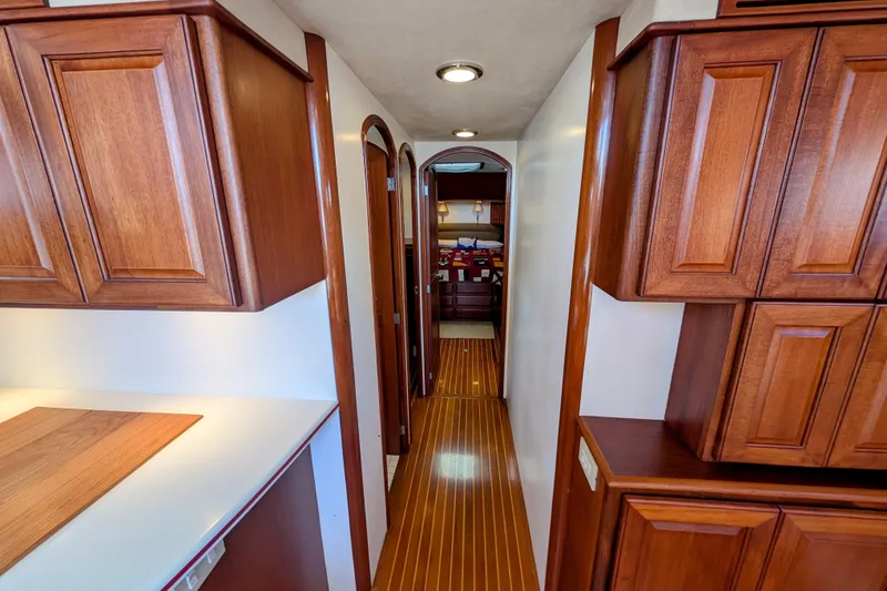 Slide: The Image of Luxurious wooden interior of 2002 Legacy Yachts 52 Express, featuring elegant cabinetry and flooring. - 30