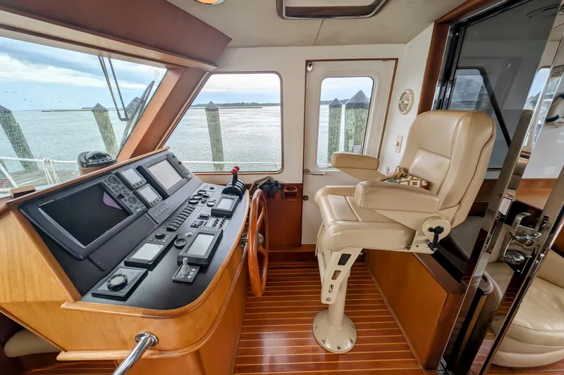 Slide: The Image of Helm of 2002 Legacy Yachts 52 Express with navigation equipment and captain's chair. - 32