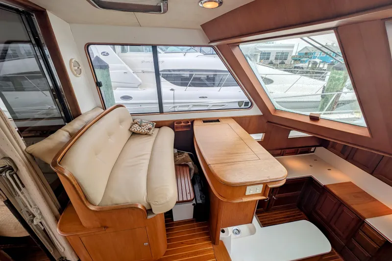 Slide: The Image of Interior of 2002 Legacy Yachts 52 Express, featuring elegant wood finishes and comfortable seating. - 33