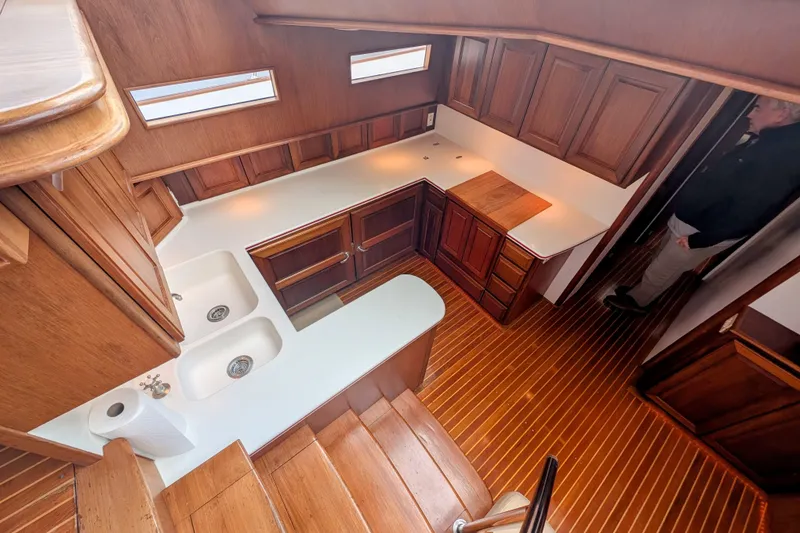 Slide: The Image of Interior of 2002 Legacy Yachts 52 Express, featuring wooden cabinetry and countertops. - 34