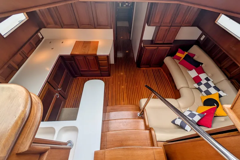 Slide: The Image of Luxurious interior of 2002 Legacy Yachts 52 Express with wood finish and colorful cushions. - 35