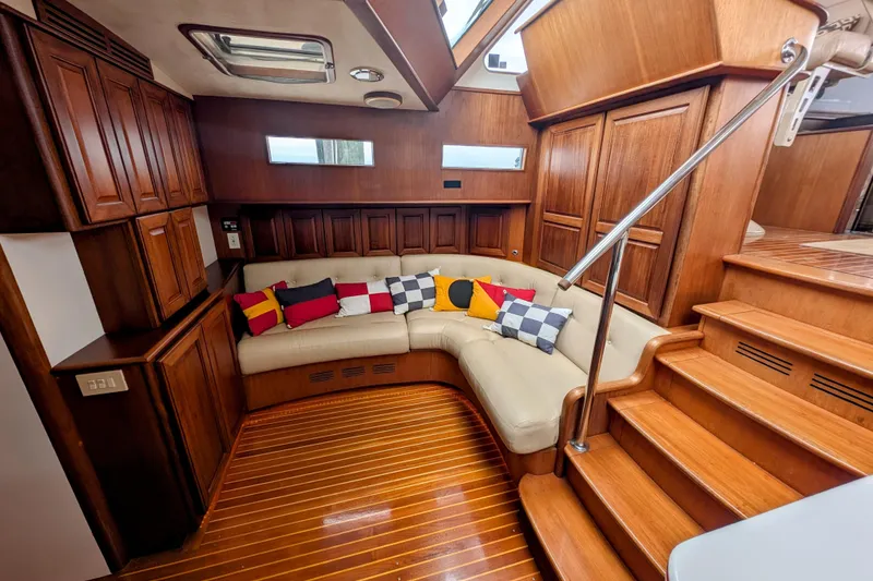 Slide: The Image of Luxurious 2002 Legacy Yachts 52 Express interior with plush seating and elegant wood finishes. - 36