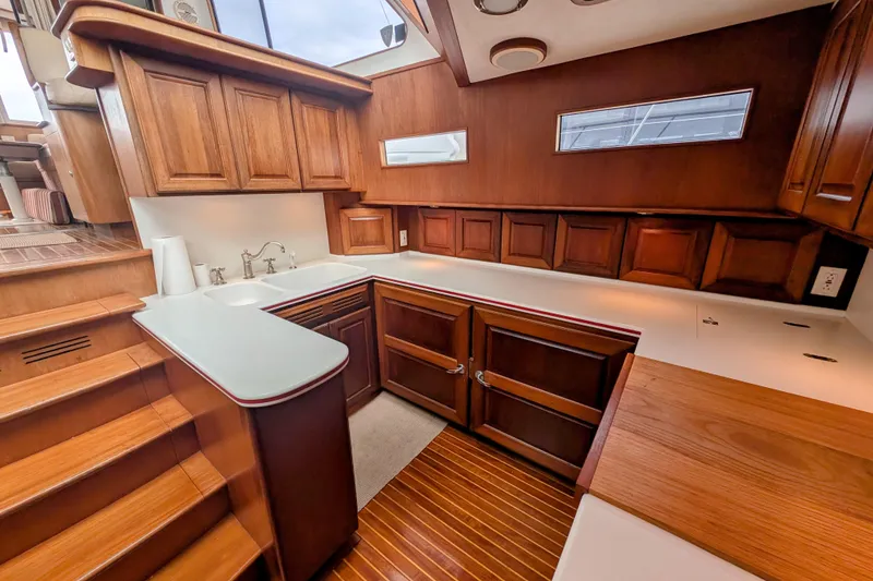 Slide: The Image of Luxurious wooden interior of 2002 Legacy Yachts 52 Express galley with modern amenities. - 37