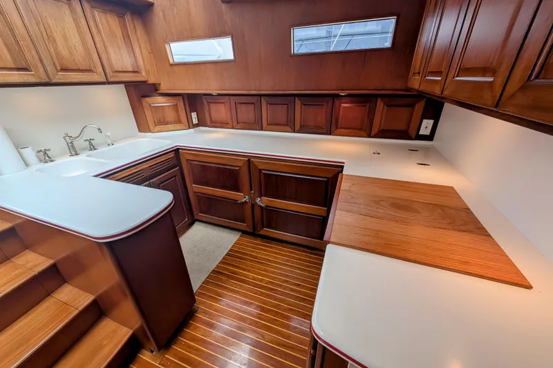 Slide: The Image of Luxurious wooden interior of 2002 Legacy Yachts 52 Express galley with modern amenities. - 38
