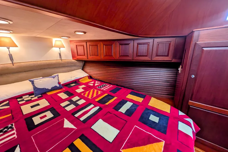 Slide: The Image of Luxurious cabin interior of 2002 Legacy Yachts 52 Express with vibrant nautical bedding. - 42