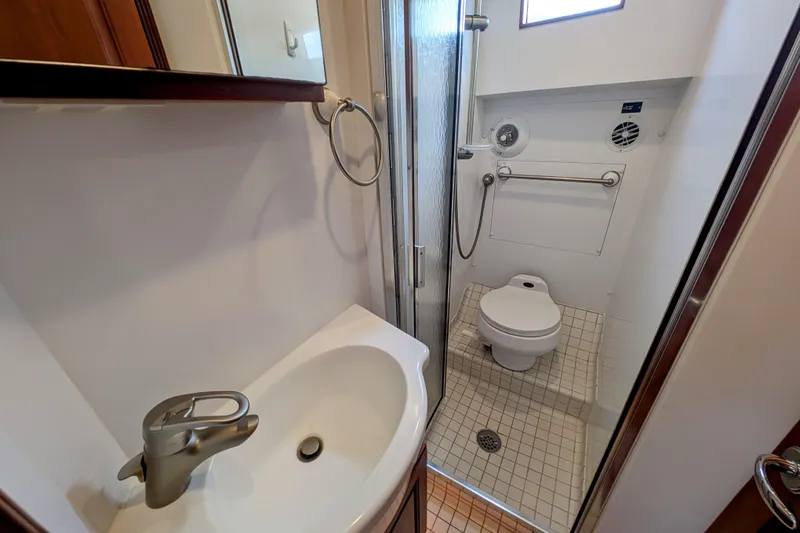 Slide: The Image of Bathroom interior of 2002 Legacy Yachts 52 Express, featuring sink, toilet, and shower. - 45