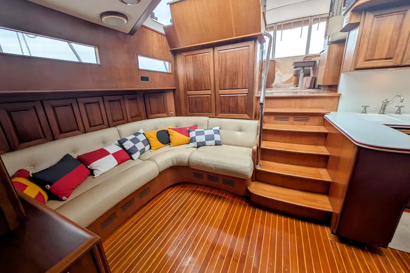 Slide: The Image of Luxurious 2002 Legacy Yachts 52 Express interior with plush seating and vibrant cushions. - 46