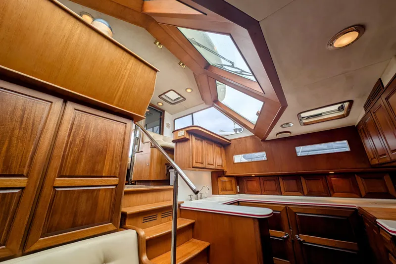 Slide: The Image of Interior of 2002 Legacy Yachts 52 Express with wooden cabinetry and skylights. - 47