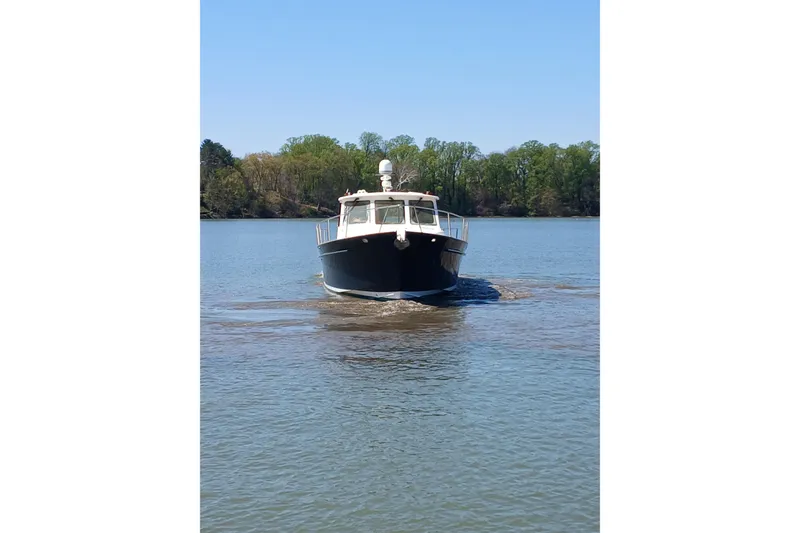 Slide: The Image of 2002 Legacy Yachts 52 Express cruising on open water. - 9
