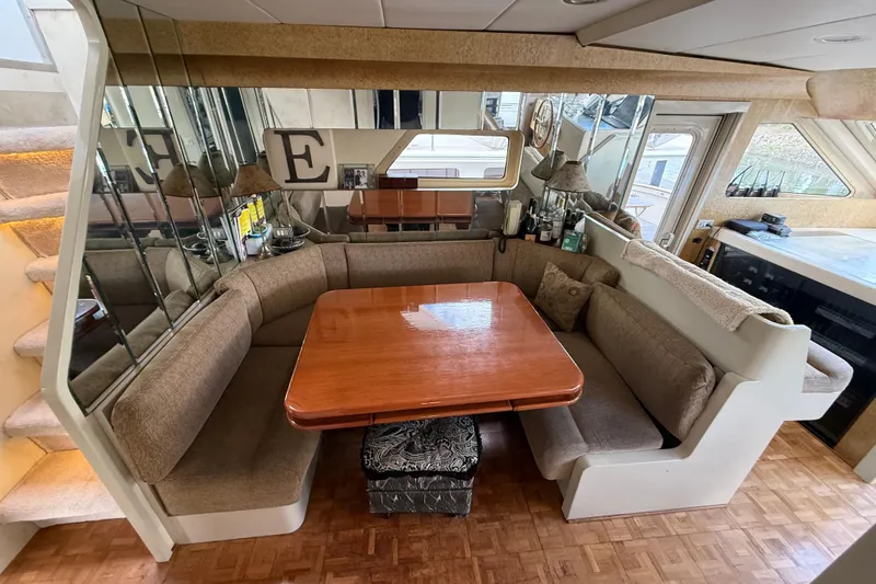 Slide: The Image of Luxurious 1988 Maiora Motor Yacht interior with cozy dining area and mirrored accents. - 10