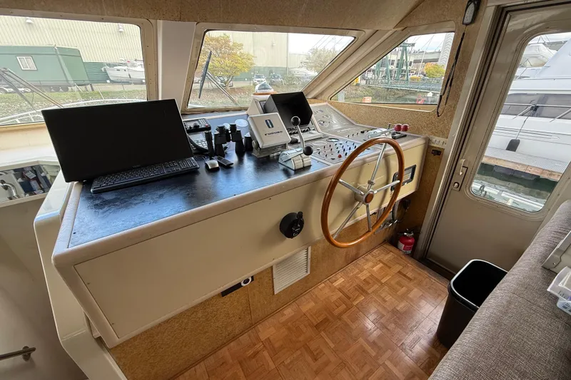 Slide: The Image of Cockpit of 1988 Maiora Motor Yacht with steering wheel and navigation equipment. - 14