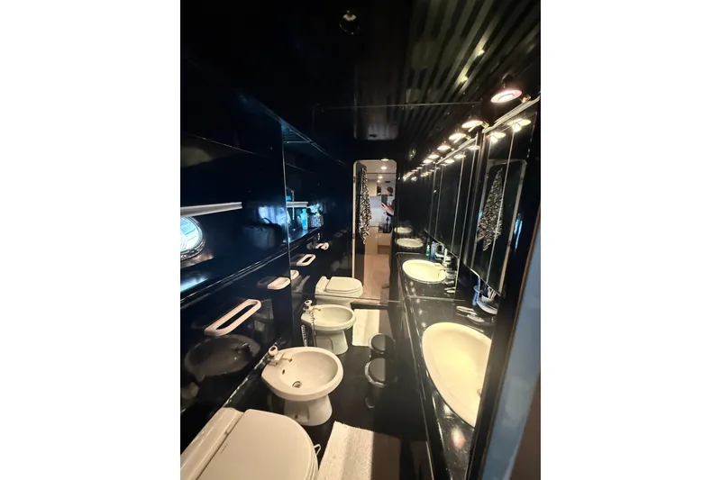 Slide: The Image of Luxurious black bathroom interior on 1988 Maiora motor yacht, featuring modern fixtures and lighting. - 16