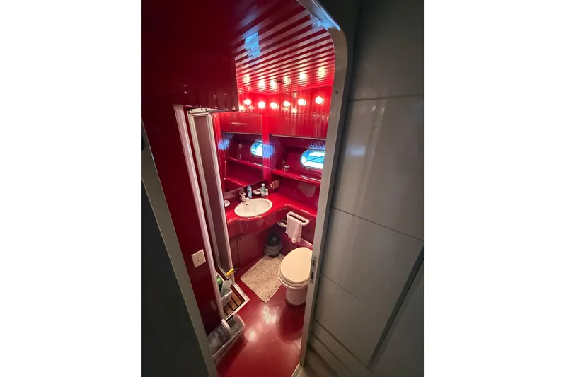 Slide: The Image of Luxurious red bathroom interior on a 1988 Maiora motor yacht. - 19