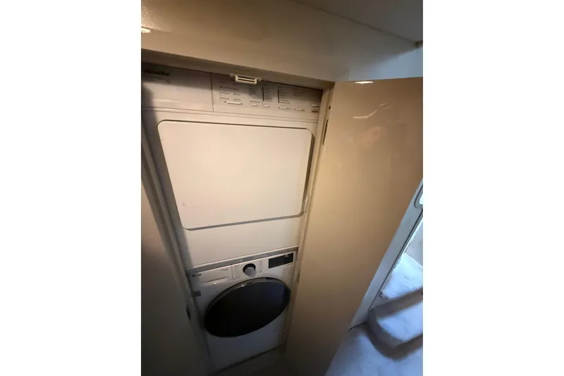 Slide: The Image of Laundry area with stacked washer and dryer on 1988 Maiora Motor Yacht. - 21