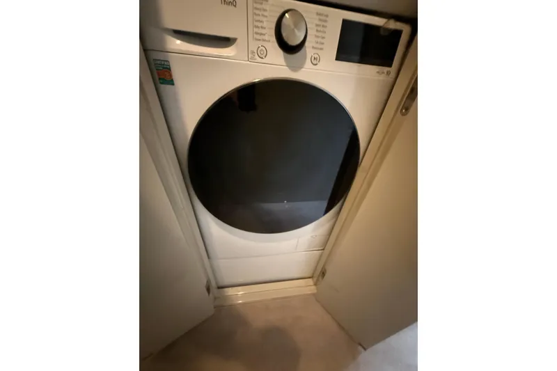 Slide: The Image of Washing machine inside 1988 Maiora Motor Yacht, compact laundry area. - 22