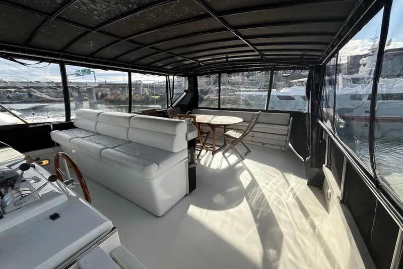 Slide: The Image of Luxurious 1988 Maiora motor yacht interior with seating and dining area, docked at marina. - 23