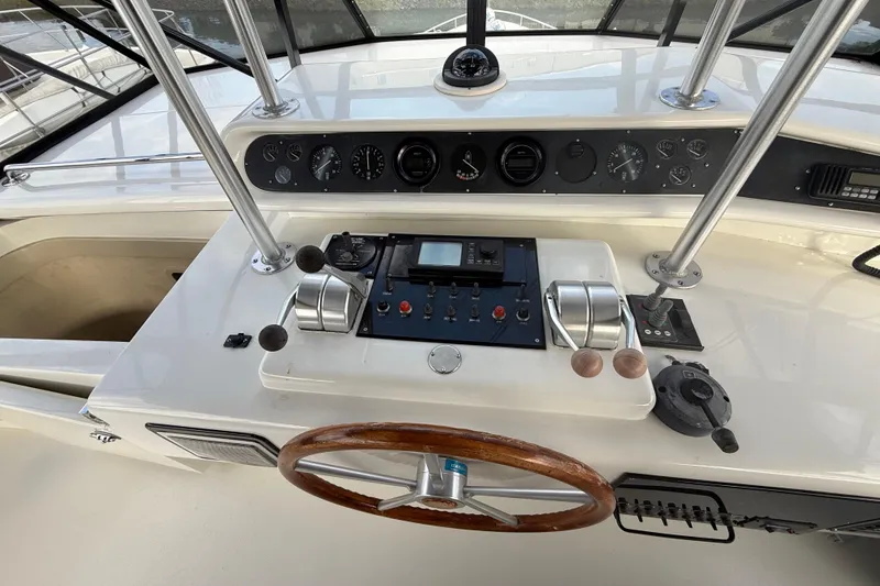 Slide: The Image of Control panel of a 1988 Maiora Motor Yacht with steering wheel and navigation instruments. - 26