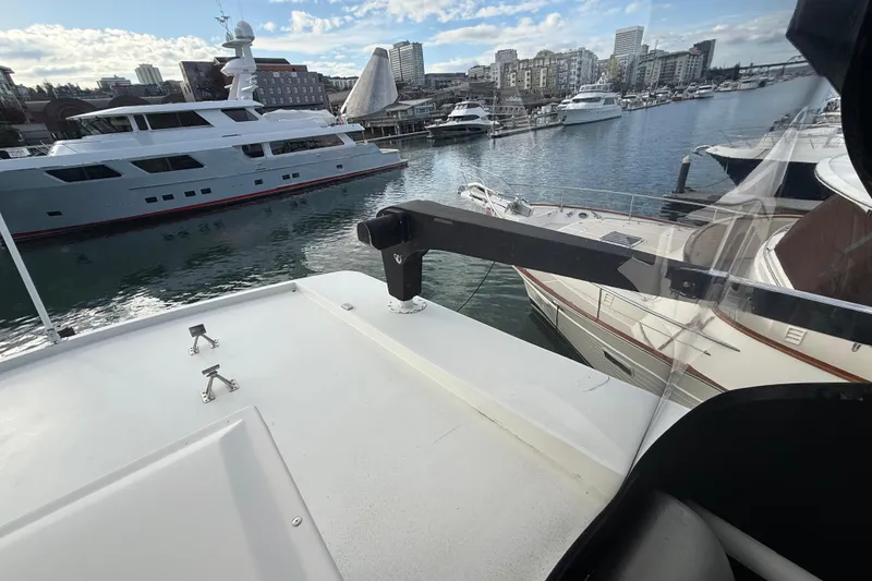 Slide: The Image of 1988 Maiora Motor Yacht docked in a marina with cityscape background. - 27