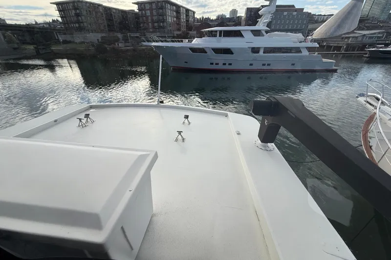 Slide: The Image of 1988 Maiora Motor Yacht docked in a marina, with urban buildings in the background. - 28
