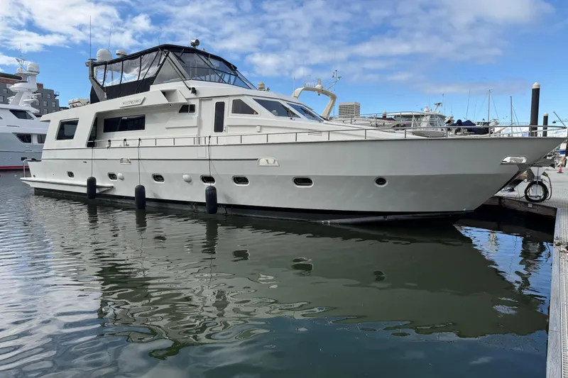 Slide: The Image of 1988 Maiora Motor Yacht docked at marina under blue sky. - 3