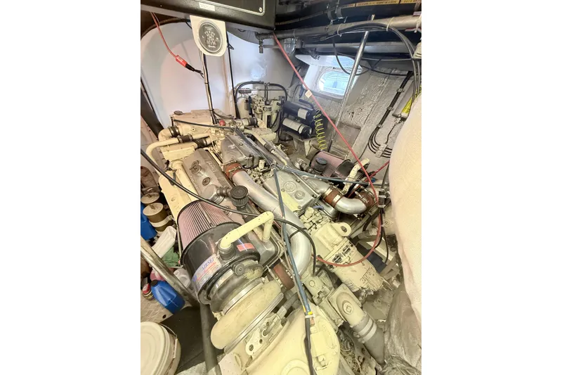 Slide: The Image of Engine room of a 1988 Maiora Motor Yacht, showcasing complex machinery and wiring. - 31