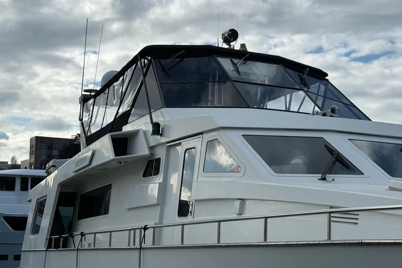 Slide: The Image of 1988 Maiora Motor Yacht with sleek design against a cloudy sky backdrop. - 5