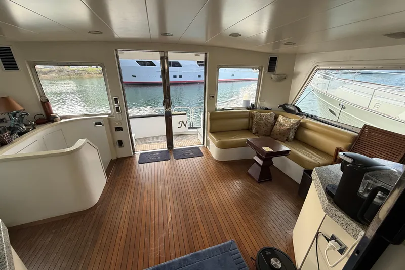 Slide: The Image of Luxurious interior of a 1988 Maiora Motor Yacht with wood flooring and plush seating. - 8