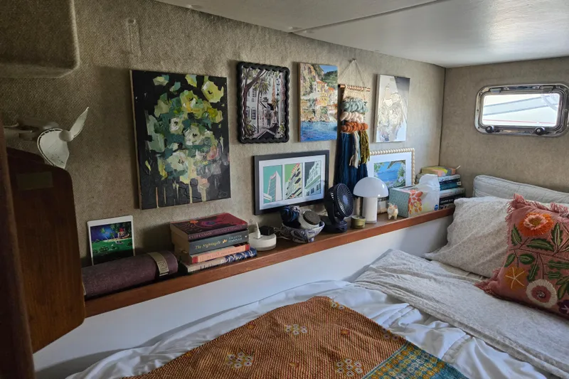 Slide: The Image of Cozy cabin interior of 2003 Endeavour Trawler Cat 44 with art, books, and decor. - 10