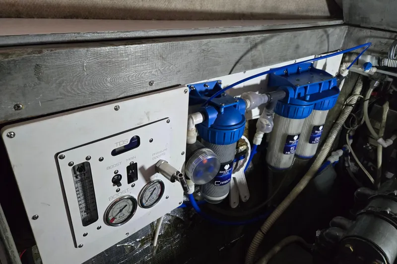 Slide: The Image of Engine room of 2003 Endeavour Trawler Cat 44 with water filtration system and control panel. - 102