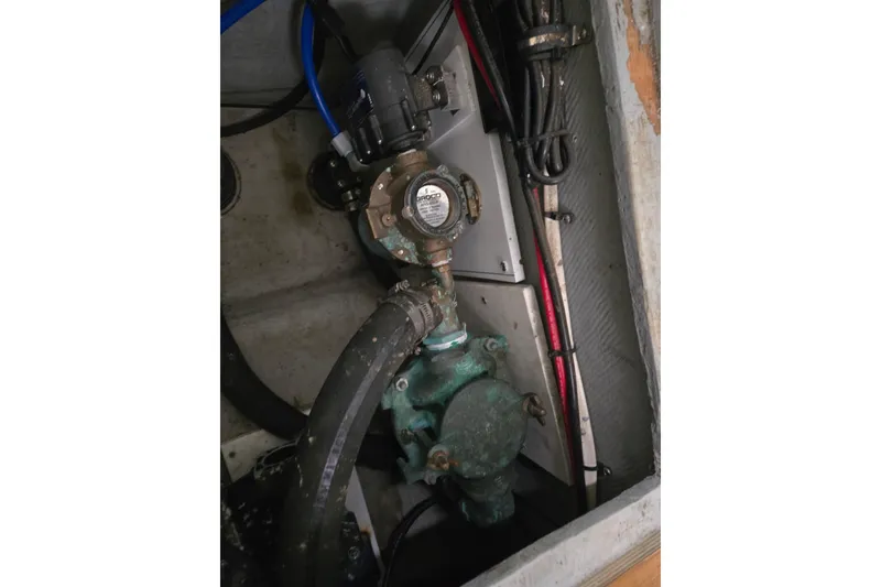 Slide: The Image of Engine compartment of 2003 Endeavour Trawler Cat 44, featuring hoses and mechanical components. - 105